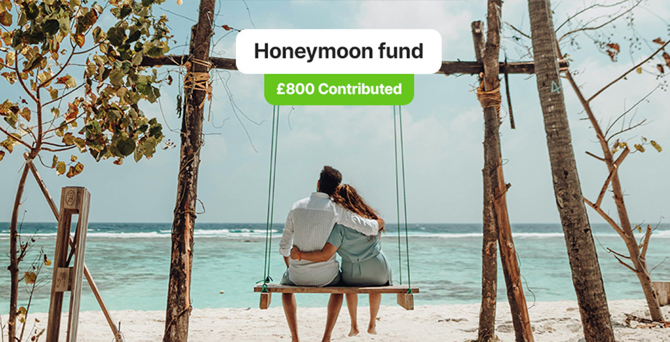 Couple on Honeymoon sitting on a swing over looking the sea