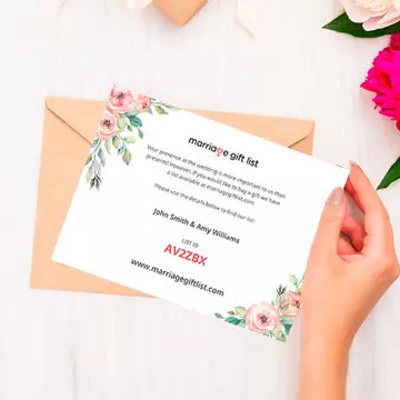 Ladies hand holding a gift list invitation card on a table.